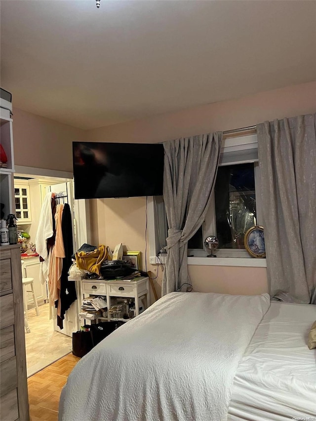 bedroom featuring a closet and light parquet flooring