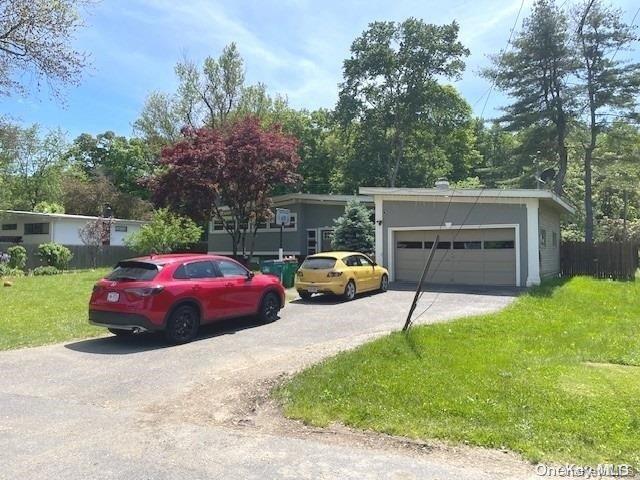 view of front of house featuring a front lawn and a garage