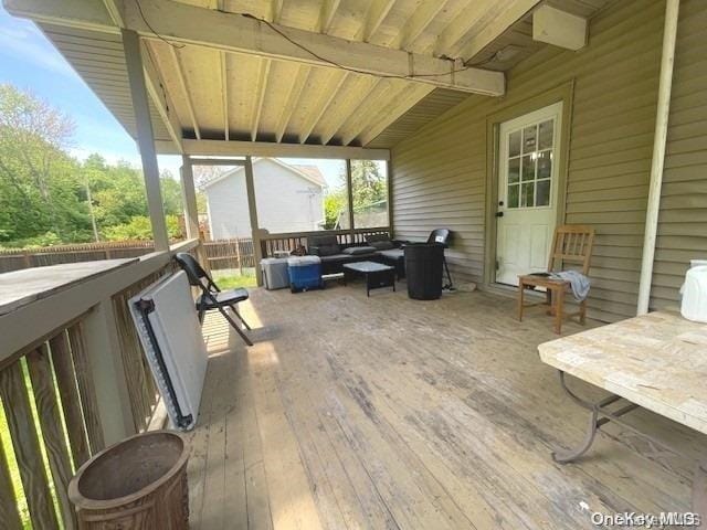 wooden deck with an outdoor living space