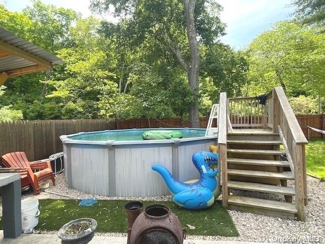 view of swimming pool with a deck