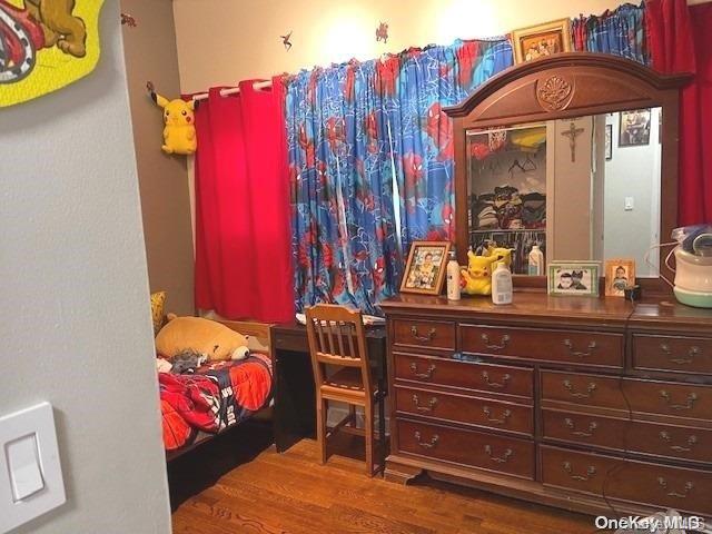 bedroom with dark hardwood / wood-style floors