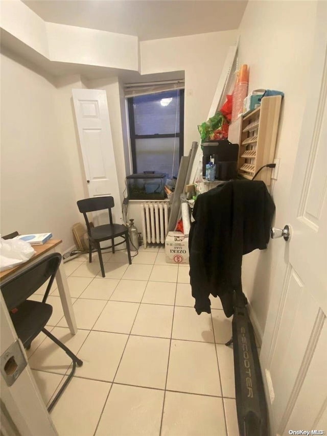 interior space with tile patterned flooring and radiator