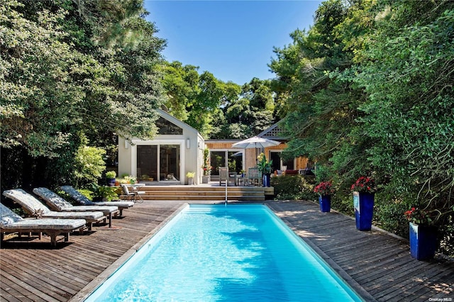 view of swimming pool featuring an outdoor structure and a deck