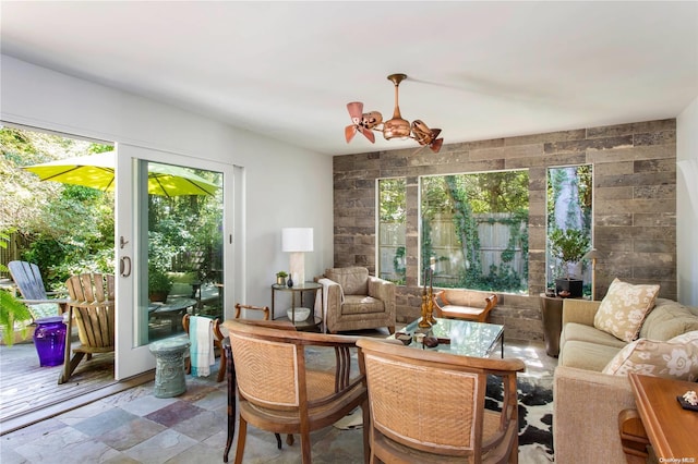 sunroom / solarium featuring a chandelier