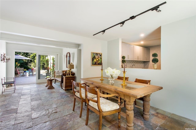 dining space featuring track lighting