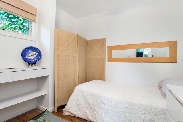 bedroom with hardwood / wood-style flooring