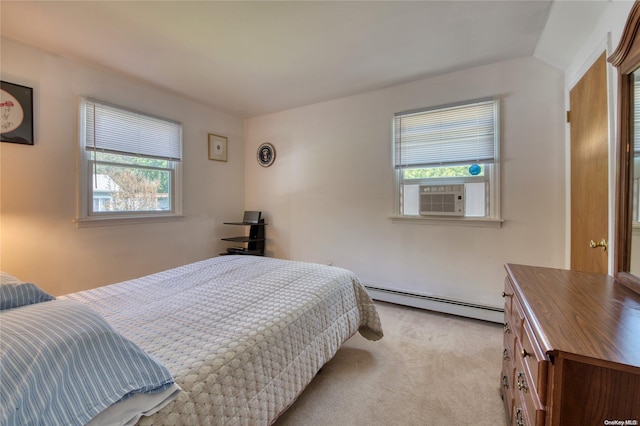 carpeted bedroom featuring cooling unit, multiple windows, and a baseboard heating unit