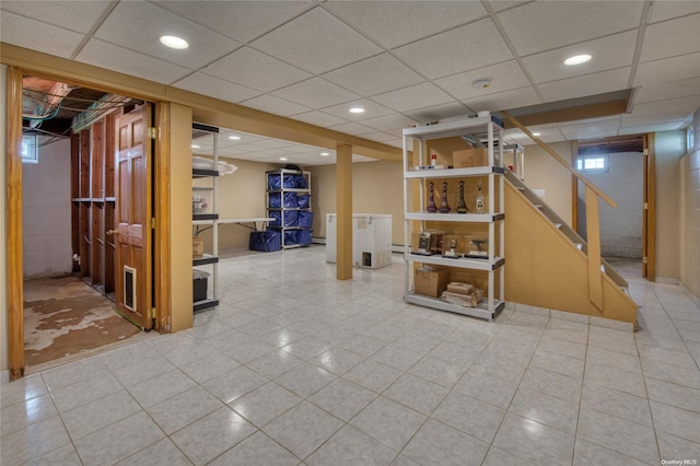 basement featuring a drop ceiling