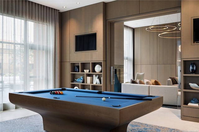 playroom with an inviting chandelier and billiards