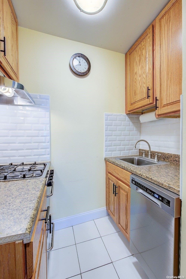 kitchen with light tile patterned flooring, sink, appliances with stainless steel finishes, and tasteful backsplash