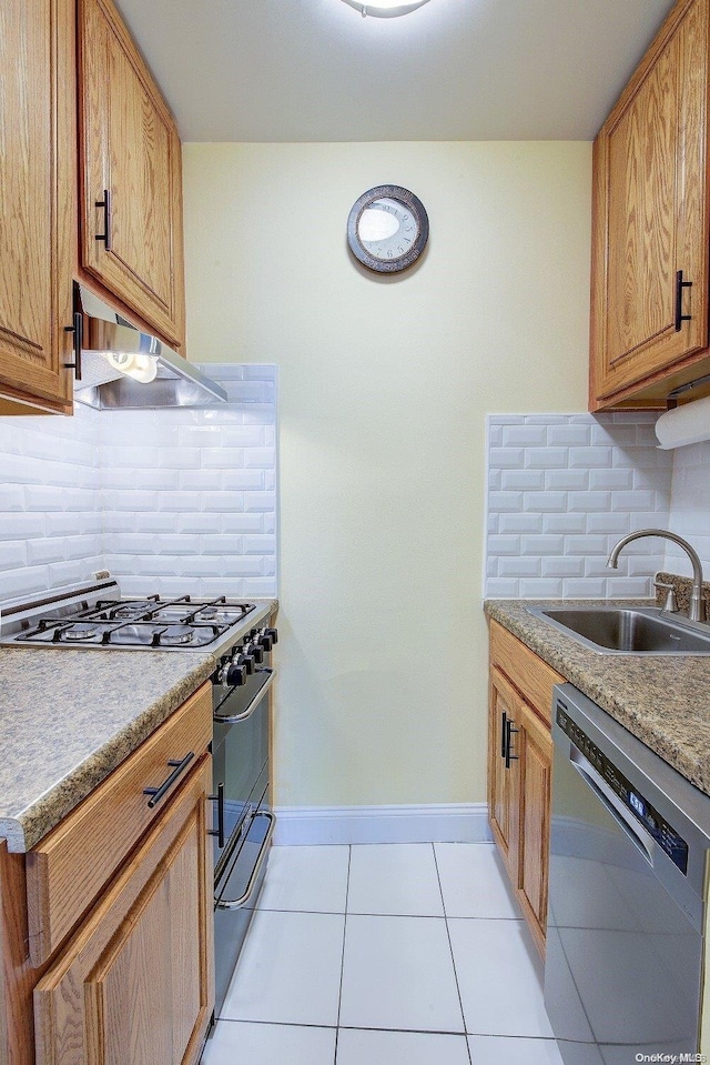 kitchen featuring sink, light tile patterned floors, range hood, tasteful backsplash, and stainless steel appliances