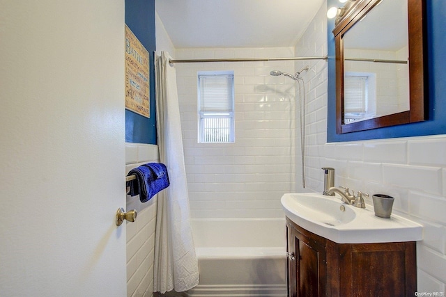 bathroom featuring decorative backsplash, shower / bath combo, and vanity