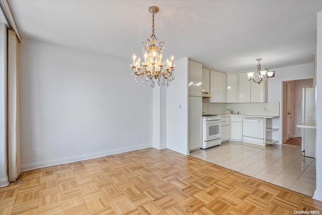 kitchen with white cabinetry, sink, light parquet floors, pendant lighting, and white appliances