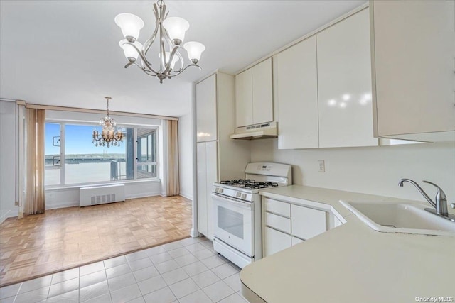 kitchen featuring white cabinets, a water view, sink, and white range with gas cooktop