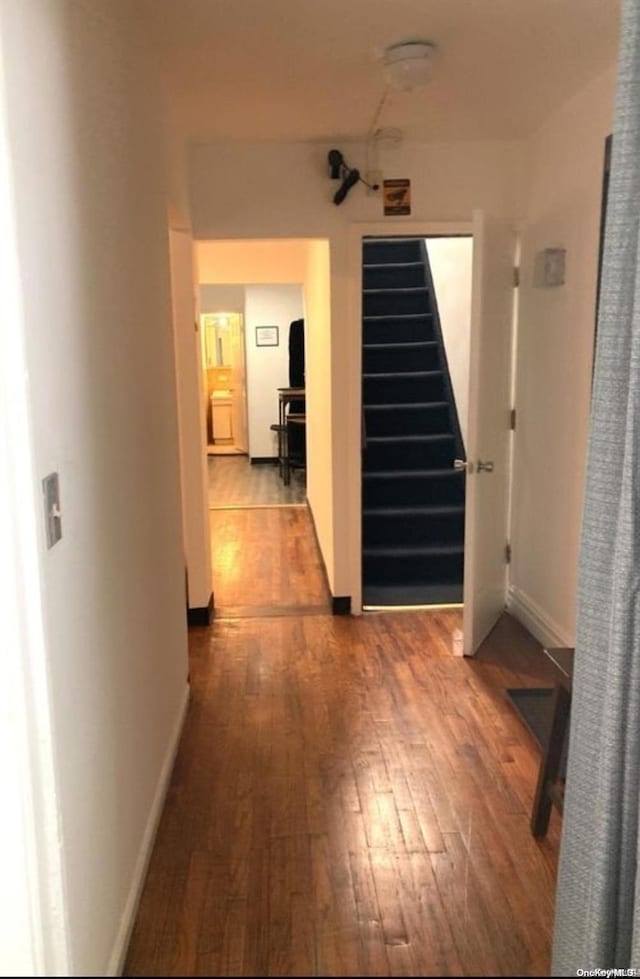 corridor with wood-type flooring