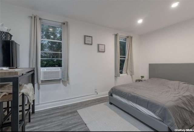 bedroom featuring dark hardwood / wood-style floors and cooling unit