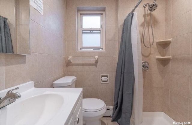 bathroom featuring vanity, toilet, baseboard heating, tile walls, and walk in shower