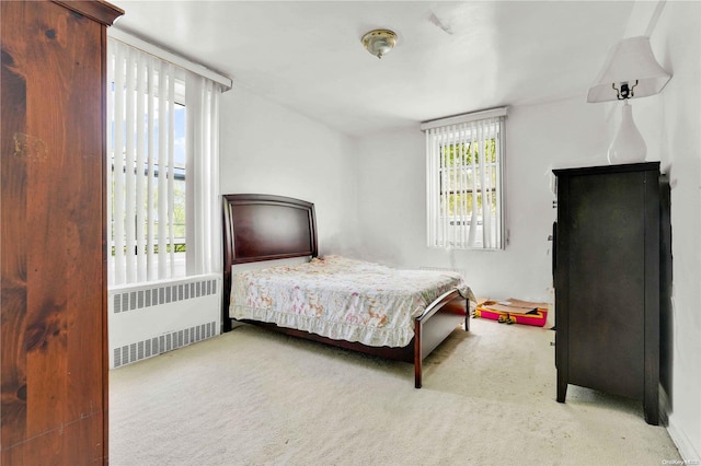 carpeted bedroom with radiator