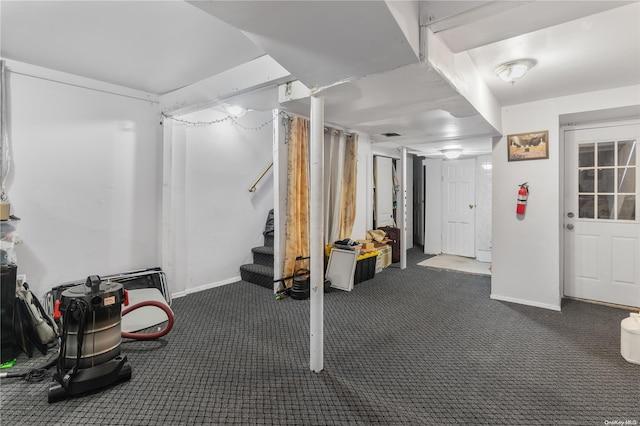 basement featuring dark colored carpet