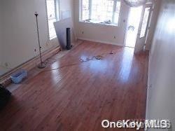 interior space featuring radiator and hardwood / wood-style flooring