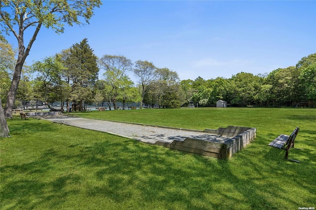 surrounding community featuring a lawn and a shed