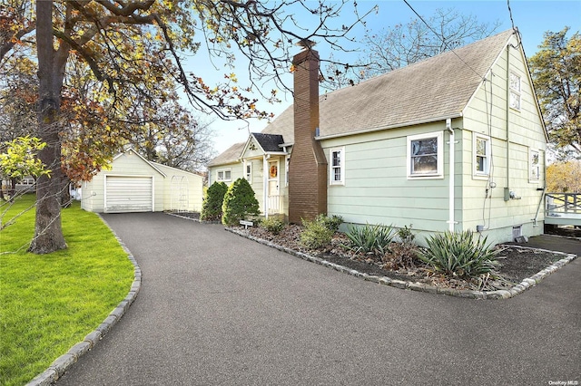 view of front facade featuring an outdoor structure and a garage