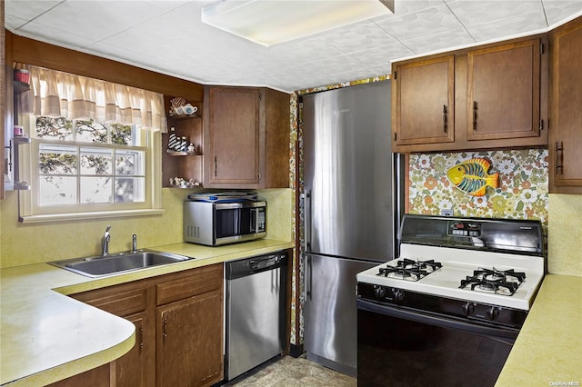 kitchen featuring appliances with stainless steel finishes, backsplash, and sink