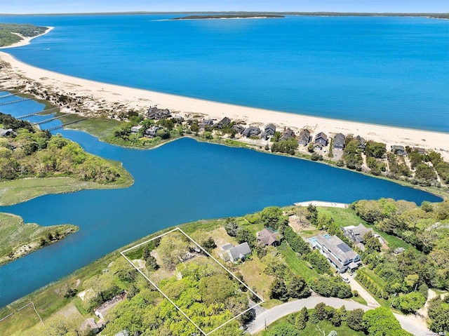 drone / aerial view with a water view and a view of the beach