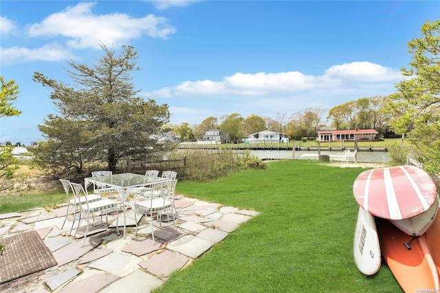 view of yard with a water view and a patio area