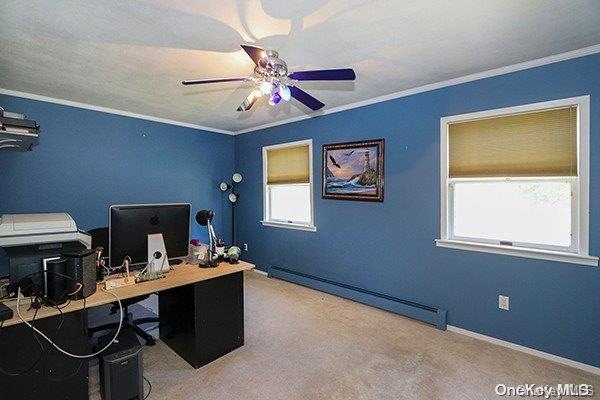 home office with carpet flooring, baseboard heating, a healthy amount of sunlight, and ceiling fan