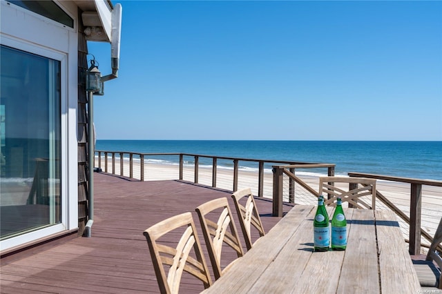 balcony with a water view and a view of the beach