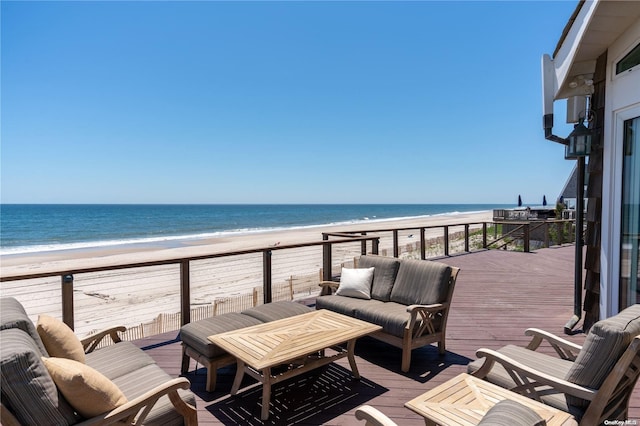 exterior space with a beach view, an outdoor hangout area, and a water view