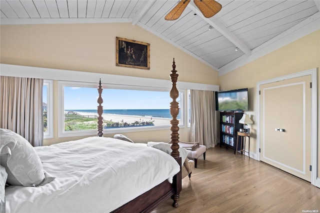 bedroom with hardwood / wood-style floors, ceiling fan, vaulted ceiling with beams, and wooden ceiling