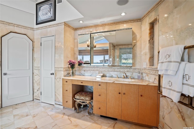 bathroom with vanity and tile walls