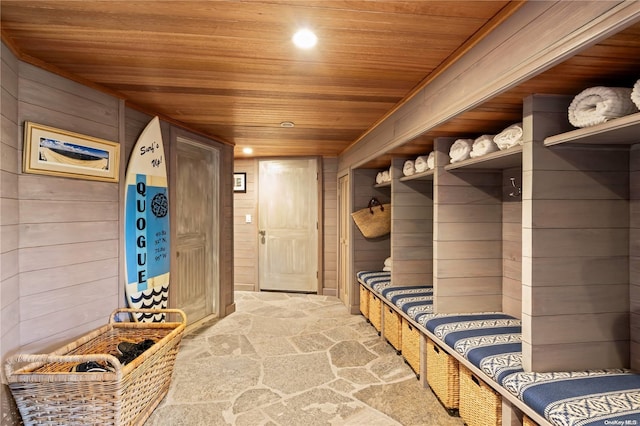 mudroom featuring wood walls, wood ceiling, and carpet floors