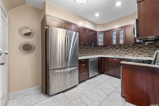 kitchen featuring decorative backsplash, dark brown cabinets, sink, and appliances with stainless steel finishes