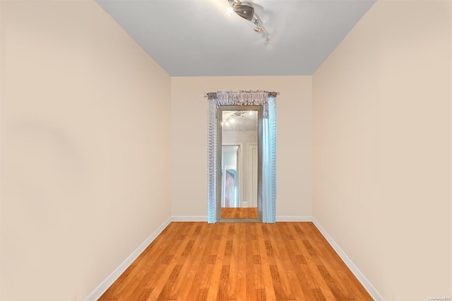 unfurnished room with light wood-type flooring