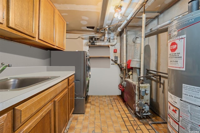 clothes washing area featuring sink, cabinets, and gas water heater