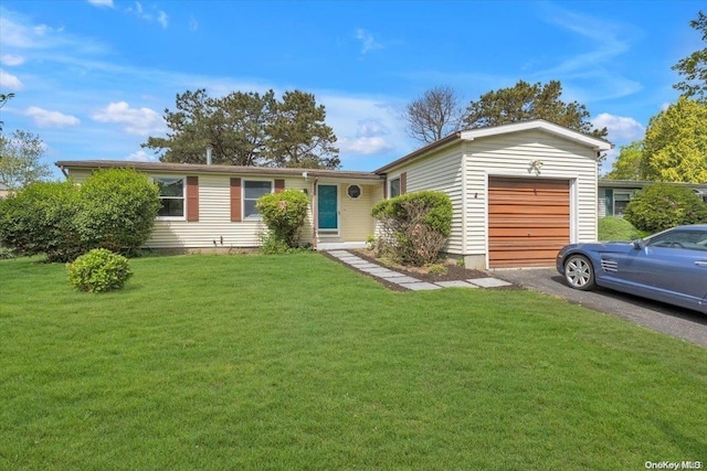 single story home with a front yard and a garage