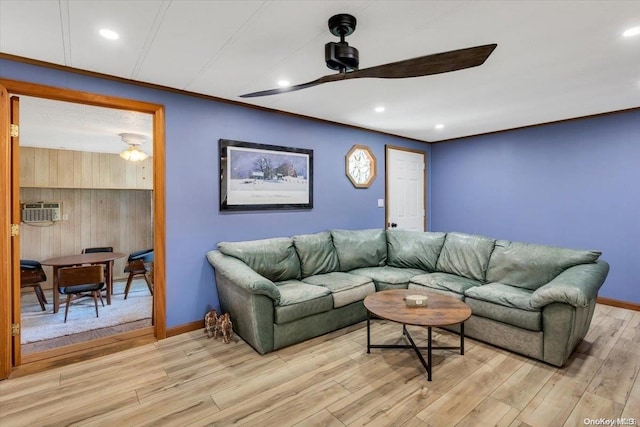 living room with light wood-type flooring, a wall unit AC, and ceiling fan