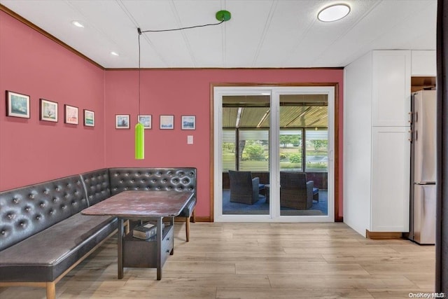 interior space with breakfast area and light hardwood / wood-style floors