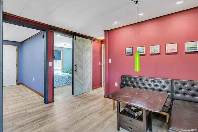 interior space featuring a barn door and light wood-type flooring