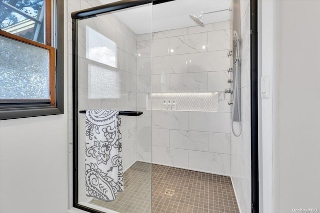 bathroom with a shower with door and a wealth of natural light