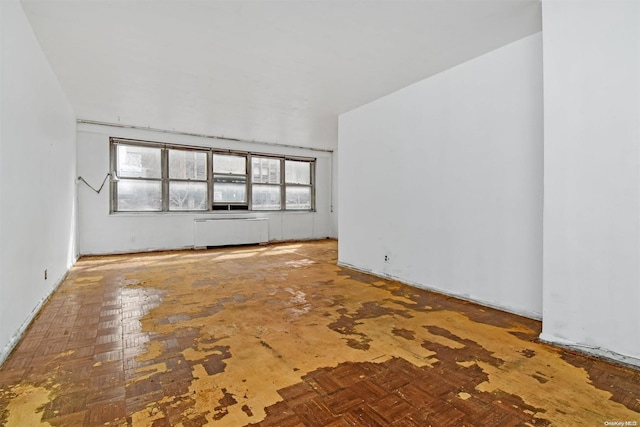 unfurnished living room featuring radiator heating unit