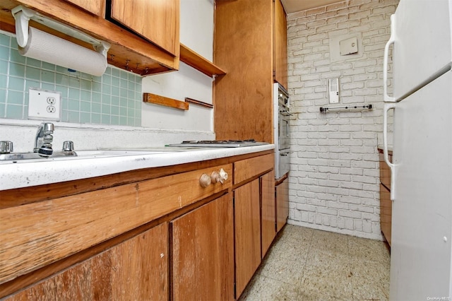 kitchen with white fridge and stainless steel gas cooktop