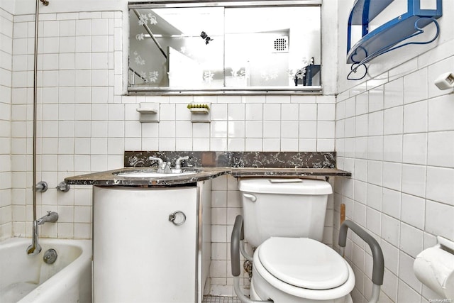 full bathroom with vanity, toilet, tile walls, and bathing tub / shower combination