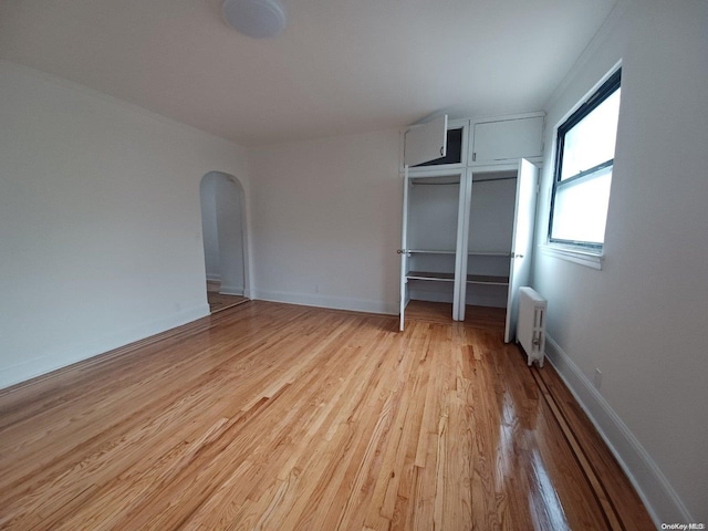 unfurnished bedroom with radiator and light hardwood / wood-style flooring