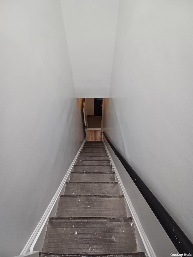 stairs with hardwood / wood-style floors