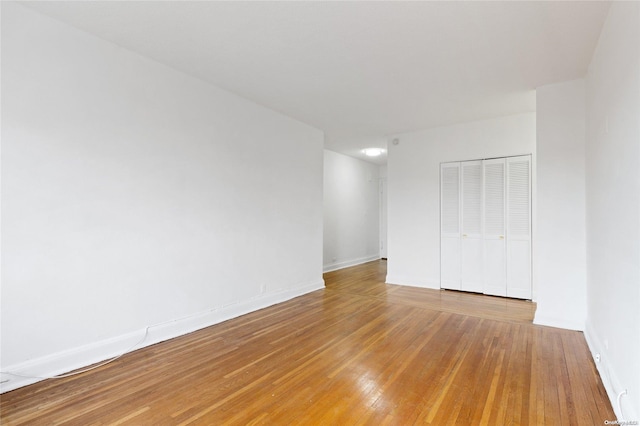 empty room with hardwood / wood-style floors