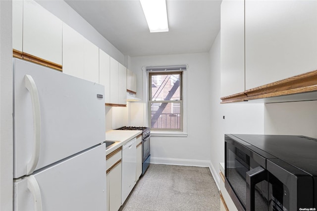 kitchen with white cabinets and white appliances